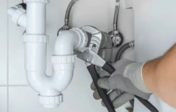 Plumber-Using-Wrench-On-Sink-Drain-Pipes